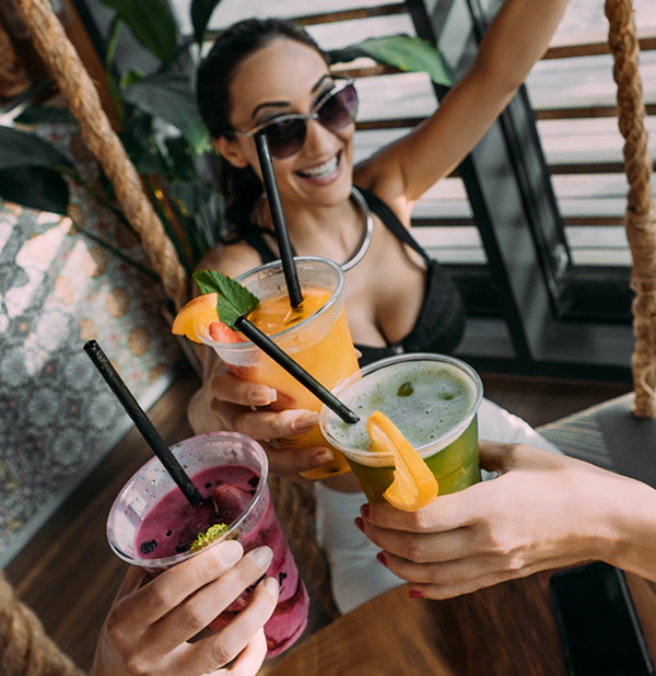 woman toasting with fruit drink