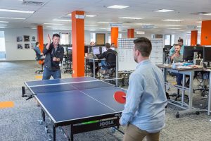 Two People Playing Ping Pong at Work
