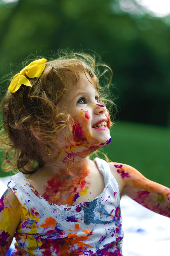 Little Girl Smiling Paint All Over