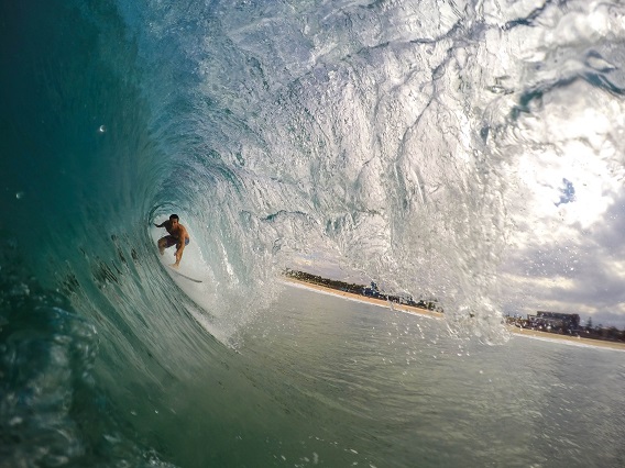 Man Surfing under A Wave