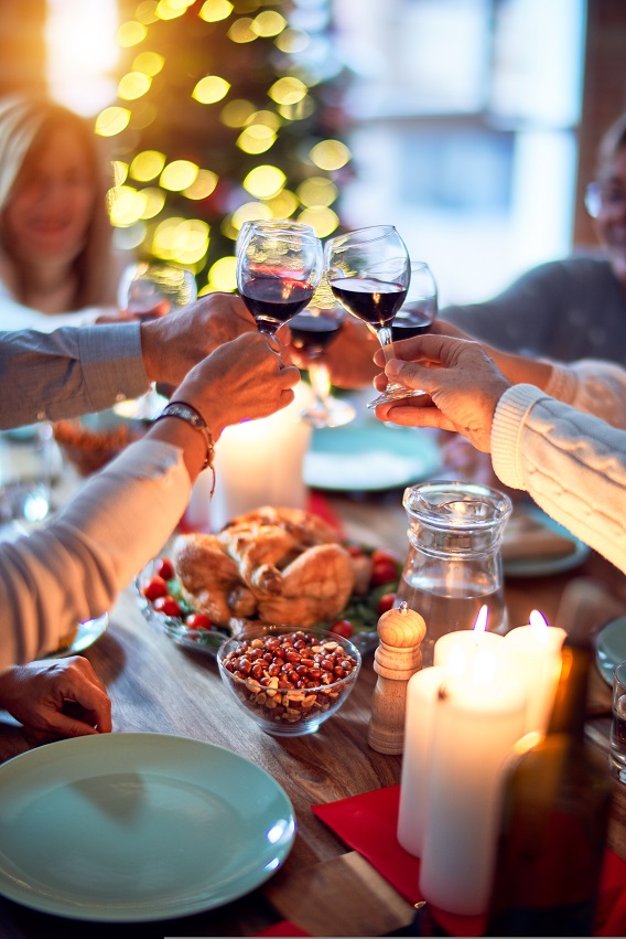 4 hands Toasting Thanksgiving Wine at Table