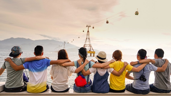 People Sitting With Arms On Shoulders