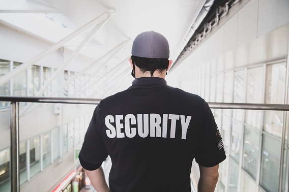 Man With Security On Back Of Shirt