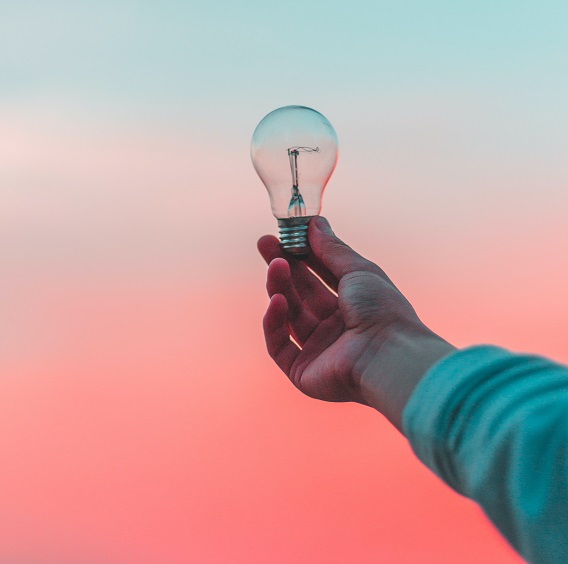 Outstreched Hand Holding A Light Bulb